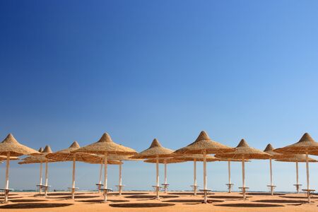 blue sky and umbrellas on the beachの写真素材
