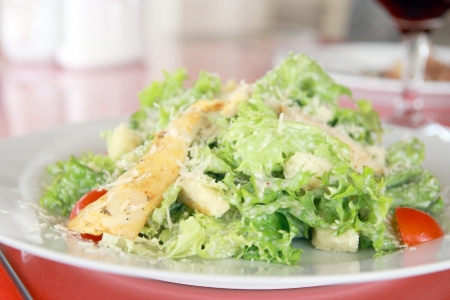 Try a caesar salad! Detail of a classic chicken caesar salad with lettuce, chicken, croutons in restaurant.の写真素材