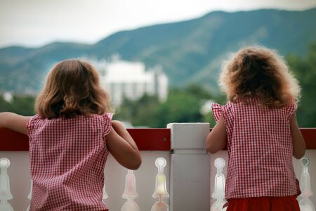 Two girls on a brige, are looking into the distance  What is there in the distance の写真素材