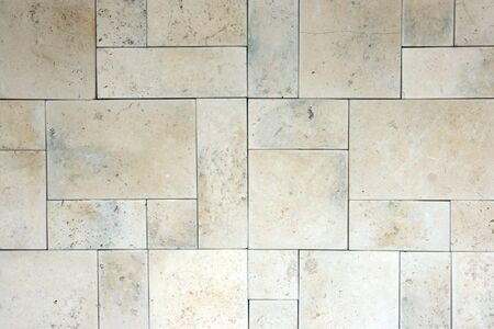 The texture of the old limestone wall can be used as background の写真素材