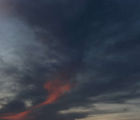 Dramatic night sky over sea. Evening sky with fluffy cloud.の写真素材