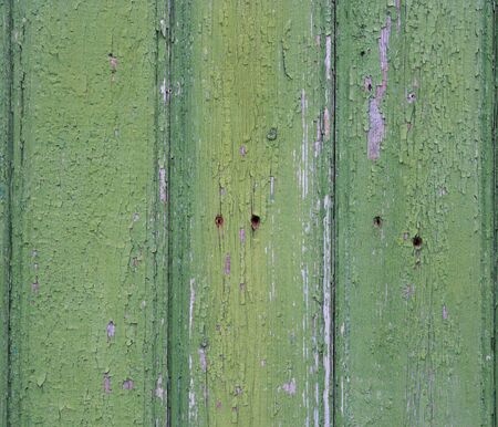 Old fence with peeling paint  Green old painted wooden backgroundの写真素材