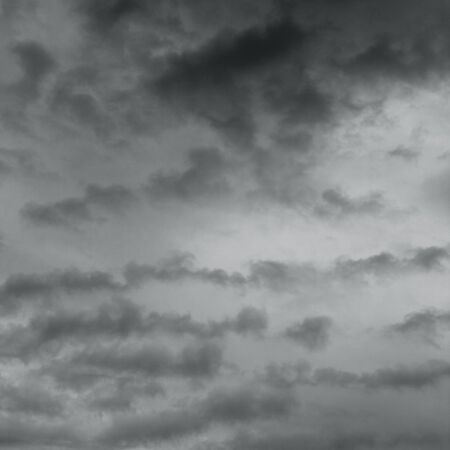 Dark sky and stormy unusual clouds. Dark ominous grey storm clouds.の写真素材