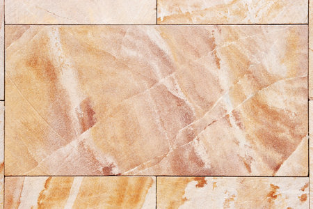 Wall from granite tiles with natural pattern 