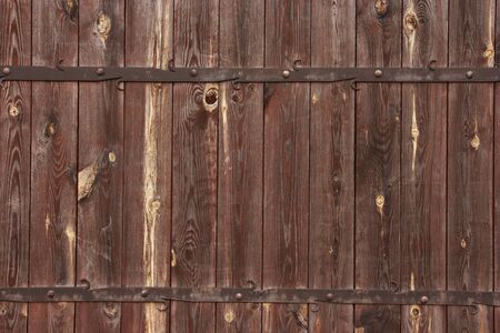 Wooden background with metal decorations  Wooden gate with forged metal decorations の写真素材