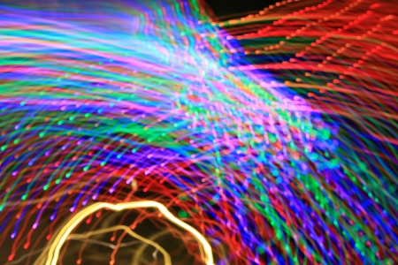 Abstract light background.Explosion of colored lights, salute, radial beams and colour lines from centre - long exposure and zoom effectの写真素材