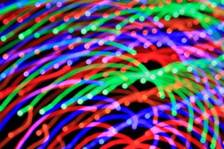 Abstract light background. Ð¡olored lights, salute, radial beams and colour lines from centre - long exposure and zoom effect. の写真素材