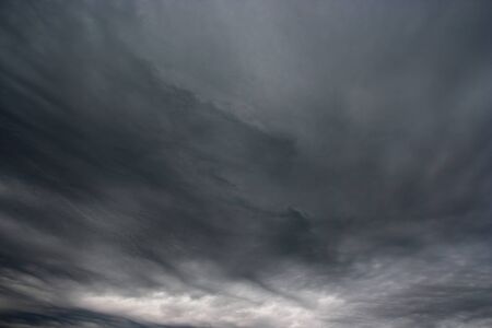 Storm clouds as if armageddon. Rainy clouds over horizon.の写真素材