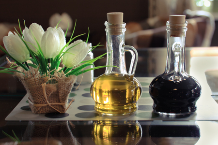 Oil and Vinegar  Free table in cozy italian cafe  Bottles of olive oil and vinegar on a table in a cafe  の写真素材