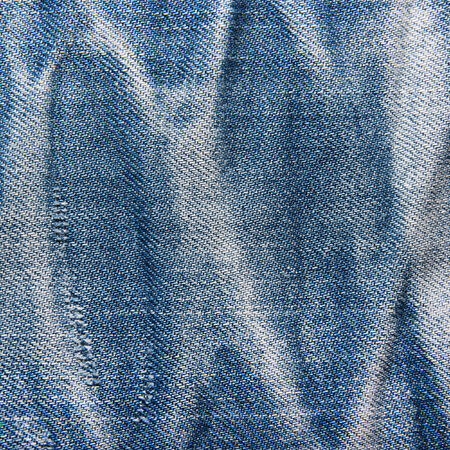 Jeans texture, background. Blue denim jeans texture with fade and striped. の写真素材