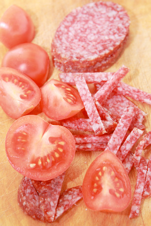 Sausage and tomatoes on a cutting board  Ingredients for italian cuisine の写真素材