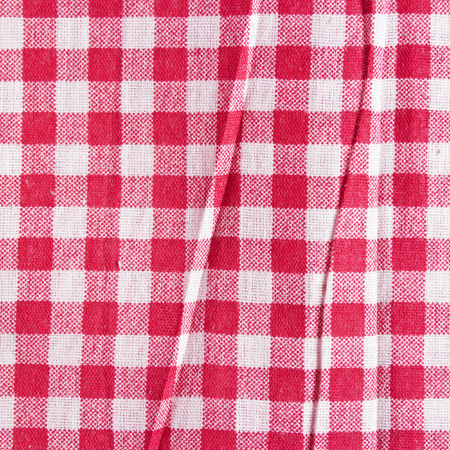 Texture of a red and white checkered picnic blanket. Red linen crumpled tablecloth.の写真素材