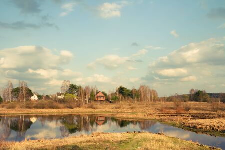 Forest lake and country houses on a coast village. Finland.の写真素材