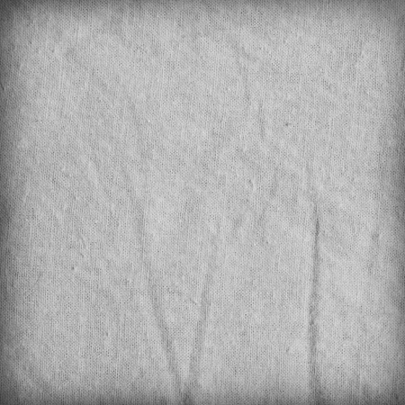 Gray fabric texture with delicate striped pattern, vignette. Cotton canvas background.の写真素材