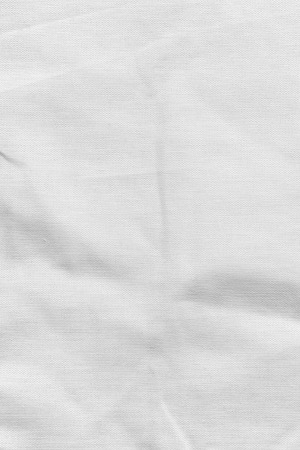 White fabric texture. Canvas with delicate striped pattern, crumpled.の写真素材