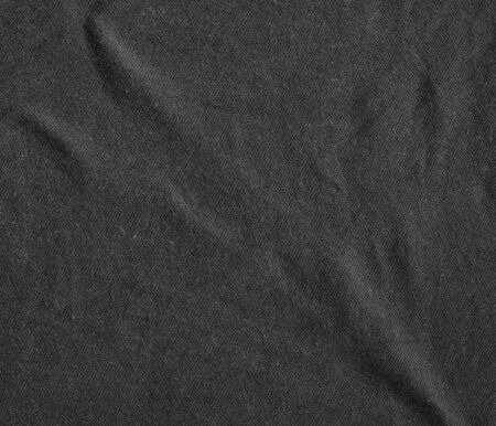 Black canvas with delicate striped pattern, crumpled. Fabric texture, background.の写真素材