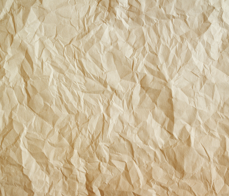 Old crumpled paper texture. Beige paper sheet as background.の写真素材