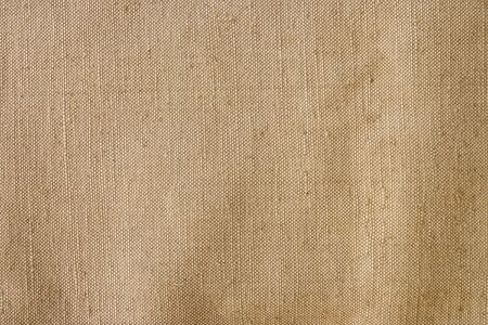 Old canvas, sackcloth. Vintage beige fabric texture, background.の写真素材