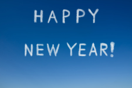 Cloudy word as "Happy new year" on clear blue sky. "Happy new year" on the sky.の写真素材