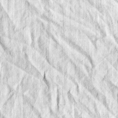 White canvas with delicate striped pattern, crumpled. Fabric texture, background.の写真素材