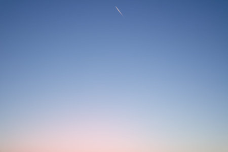 Clear evening sky and trace of an airplane or rocket. Sky background or gradient.