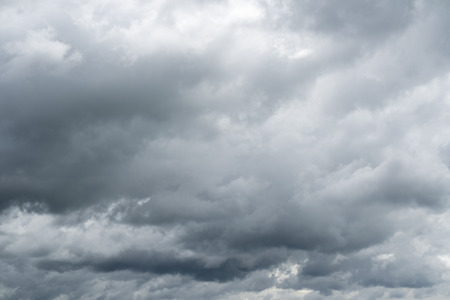 Dramatic cloudy sky. Rainy clouds flying over horizon.の写真素材