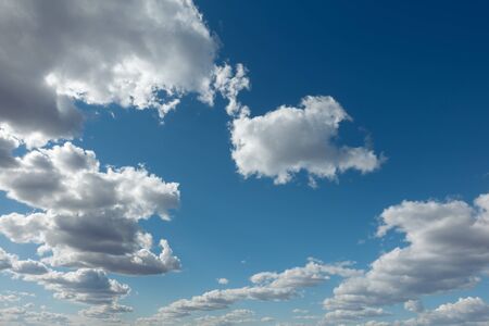 Clouds flying against blue sky at sunny day. Blue sky with clouds over horizon.の写真素材
