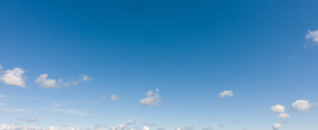 Light blue sky with clouds. Panorama white clouds flying against blue sky.の写真素材