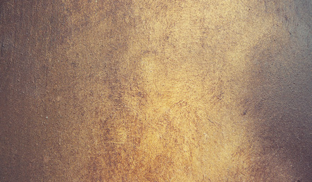 Abstract background, metalic plate with golden paint on surface. Old weathered metallic background with golden enamel.の写真素材