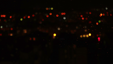 Abstract background. Night city, window and rain drops. Night view from a window.の写真素材