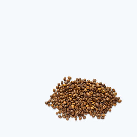 Heap of roasted coffee beans on white with copy space. Detailed image of coffee beansの写真素材