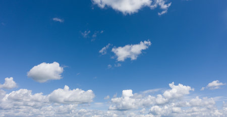 Photo of blue sky with white cloudsの写真素材