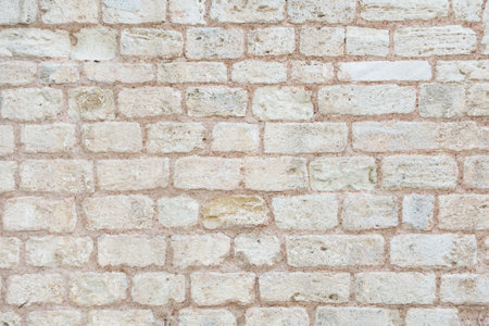 Photo of old brick wall. Beige background, texture of big brick wall.の写真素材