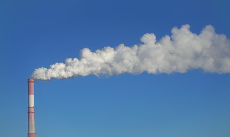 Chimney of factory and clear blue sky, environmental pollutionの写真素材