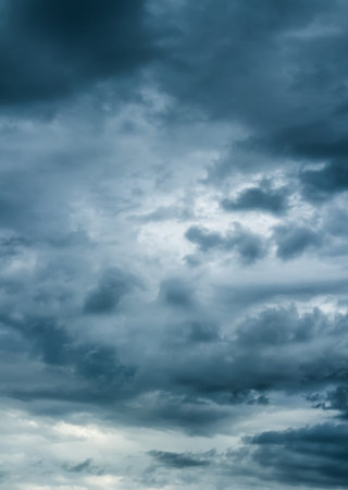 The dark sky with heavy clouds converging and a violent storm before the rain.