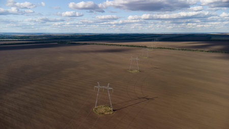 line of high-voltage transmission of electricity in an agricultural field