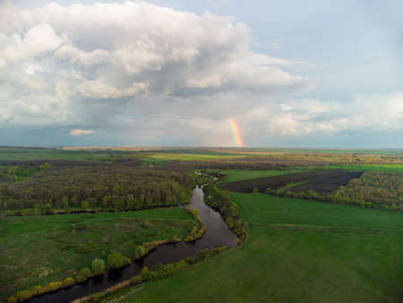 spring rainbow landscape after rain by the river aerial photoの写真素材