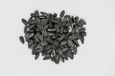 Sunflower seeds on a light background close-up. A handful of seeds. View from above