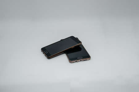 Two phones on a light background close up. Side viewの写真素材