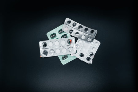 Pills on dark background close up. View from above