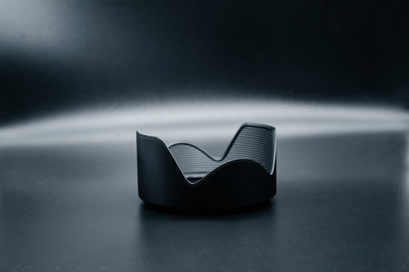 Lens hood on dark background close up. Side view