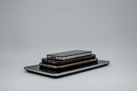 Phones and tablet on a light background close up. Side viewの写真素材
