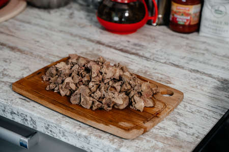 Chicken liver on a wooden board. Side viewの写真素材