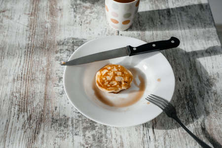 Leftover delicious breakfast. Plate with fritter. Side viewの写真素材