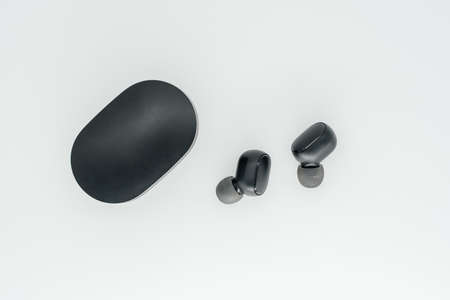 Bluetooth headphones on a light background close-up. View from aboveの写真素材