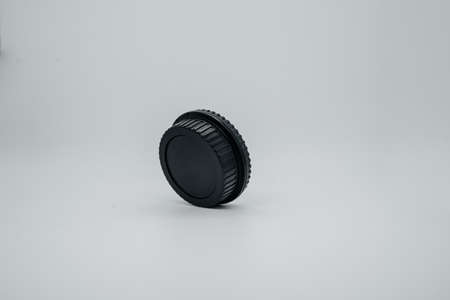 Lens cap on light background close up. Side viewの写真素材