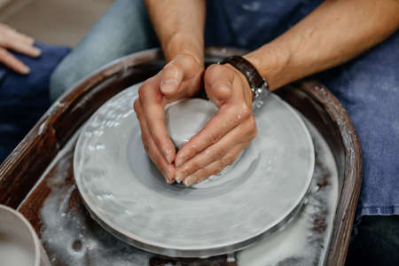 Modeling clay on a potter's wheelの写真素材