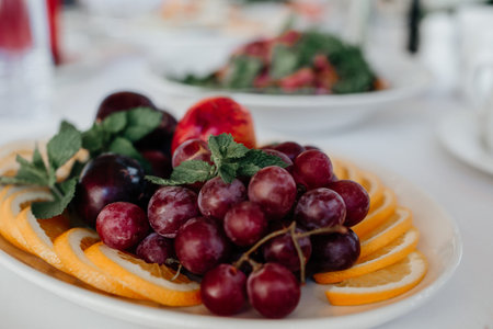 Juicy grapes on a plate in a plate on the table close-upの写真素材