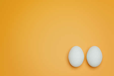 Two white chicken eggs on yellow background top view. Creative food minimalistic background.の写真素材