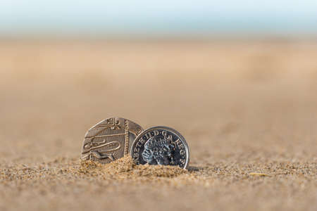 Business coins at holiday in the sand on the beach, North Seaの写真素材